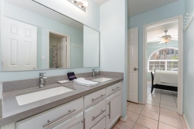 bathroom with tile patterned flooring, vanity, and ceiling fan