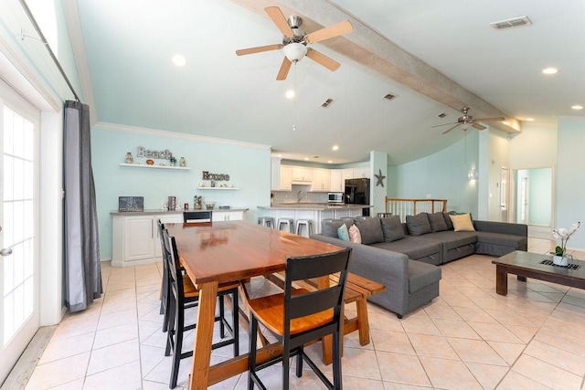 dining room featuring ceiling fan, ornamental molding, lofted ceiling with beams, and light tile patterned floors