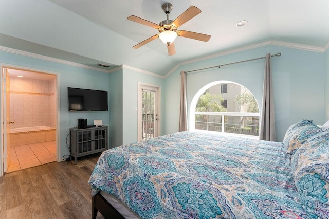 bedroom featuring crown molding, lofted ceiling, access to exterior, and hardwood / wood-style floors