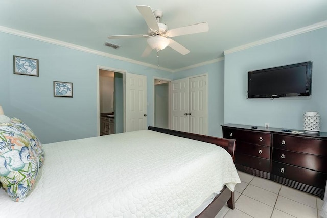 tiled bedroom with ceiling fan, ornamental molding, connected bathroom, and a closet