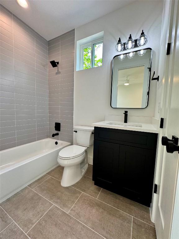 1708 Canterbury St Unit 2, Austin, TX 78702 - bathroom featuring vanity, toilet, bathtub / shower combination, and tile patterned flooring