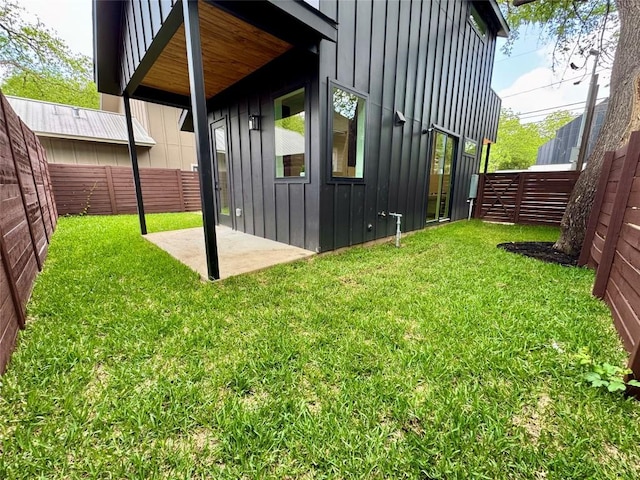 1708 Canterbury St Unit 2, Austin, TX 78702 - view of side of property with a patio, a fenced backyard, board and batten siding, and a yard