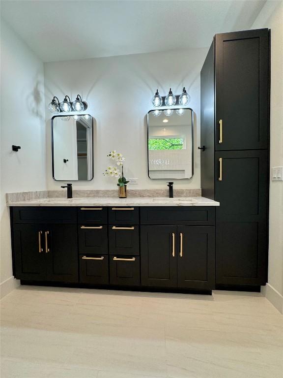 1708 Canterbury St Unit 2, Austin, TX 78702 - bathroom with double vanity and baseboards