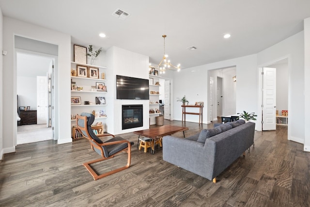 513 Elworth Path, Lakeway, TX 78738 - living area featuring dark wood-type flooring, recessed lighting, a large fireplace, and a chandelier