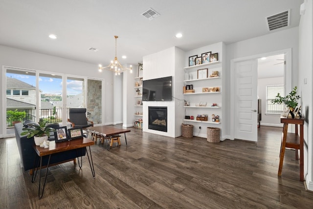 513 Elworth Path, Lakeway, TX 78738 - living area featuring dark wood-style floors, recessed lighting, a chandelier, and a glass covered fireplace