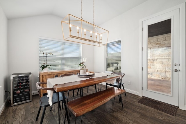 513 Elworth Path, Lakeway, TX 78738 - dining room with wine cooler, dark wood-style floors, lofted ceiling, a chandelier, and baseboards
