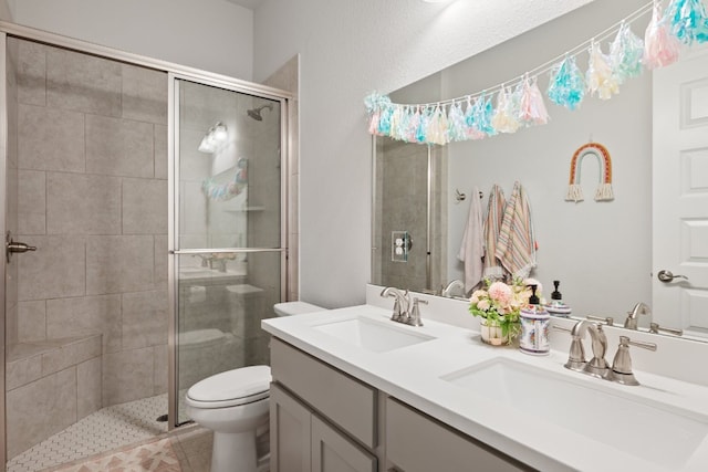 513 Elworth Path, Lakeway, TX 78738 - bathroom with toilet, a stall shower, double vanity, and tile patterned floors