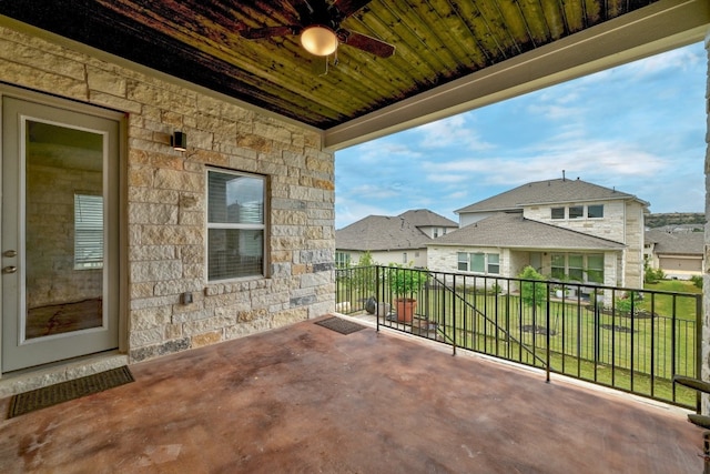 view of patio / terrace with ceiling fan and a balcony