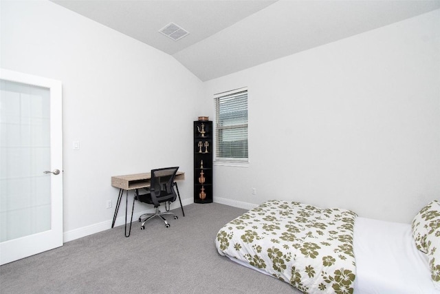 bedroom with vaulted ceiling and light colored carpet