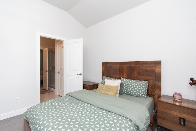 bedroom featuring vaulted ceiling and carpet flooring