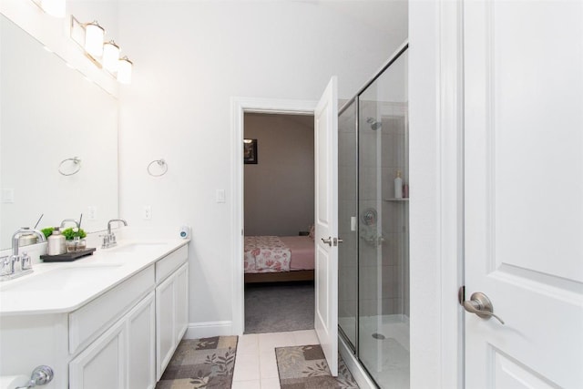 bathroom featuring vanity, tile patterned flooring, and a shower with door