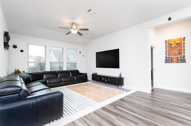 living room with lofted ceiling, hardwood / wood-style floors, and ceiling fan