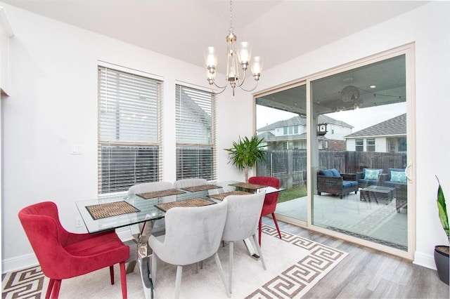 dining space with a notable chandelier and hardwood / wood-style flooring