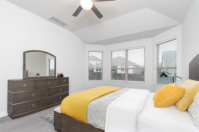 bedroom featuring vaulted ceiling, light colored carpet, and ceiling fan