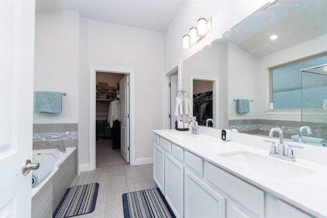 bathroom featuring vanity and a relaxing tiled tub