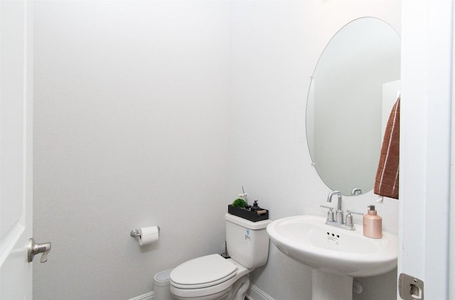 bathroom featuring toilet and sink