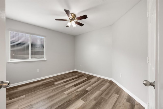 empty room featuring wood-type flooring and ceiling fan