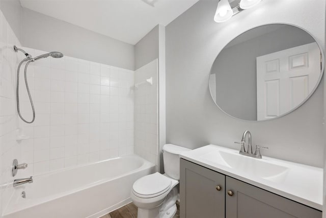 full bathroom featuring vanity, hardwood / wood-style floors, toilet, and tiled shower / bath