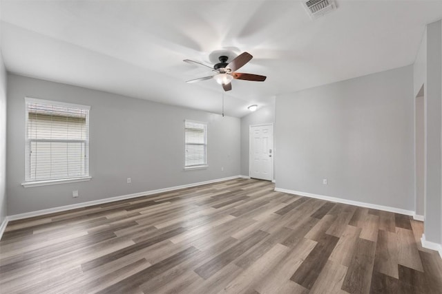 unfurnished room featuring wood-type flooring, ceiling fan, and vaulted ceiling