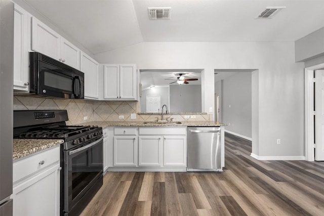 kitchen with sink, dishwasher, white cabinetry, light stone counters, and gas stove