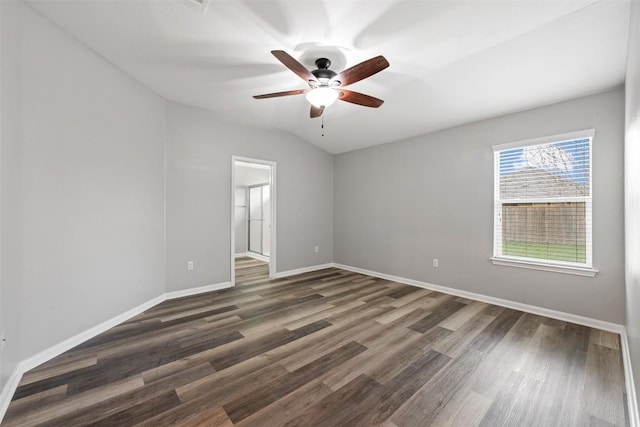 unfurnished room featuring vaulted ceiling, dark hardwood / wood-style floors, and ceiling fan