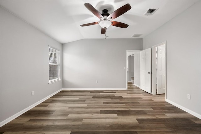 empty room featuring lofted ceiling, dark hardwood / wood-style floors, and ceiling fan