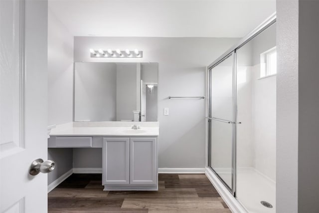 bathroom with vanity, hardwood / wood-style floors, and walk in shower