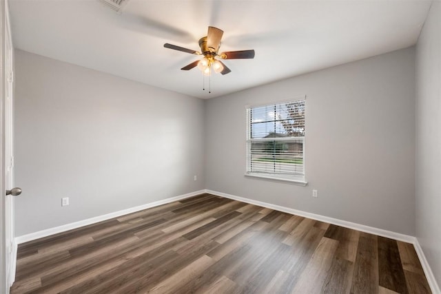 empty room with dark wood-type flooring and ceiling fan