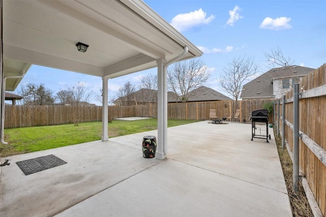 view of patio featuring a grill and a fire pit