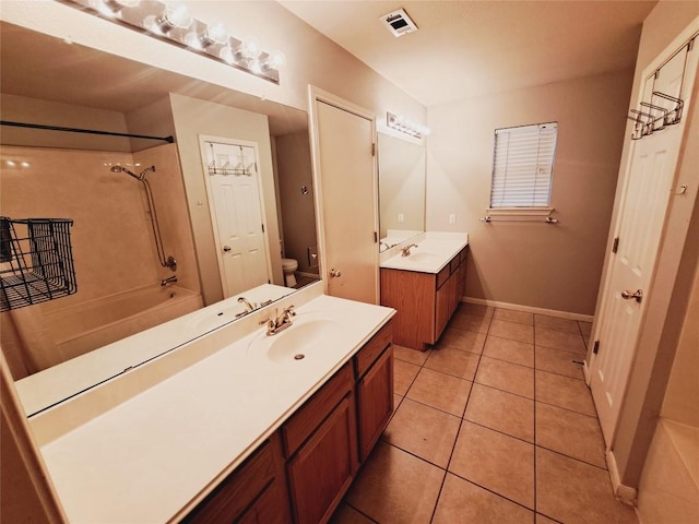 full bathroom with tile patterned flooring, vanity, shower / bath combination, and toilet