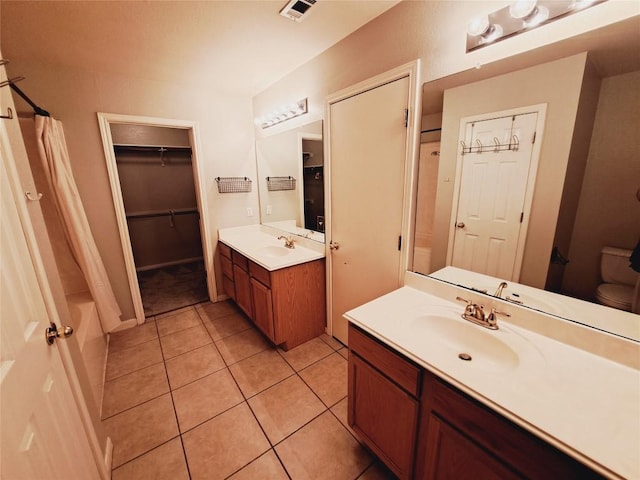 full bathroom with vanity, toilet, tile patterned floors, and shower / tub combo with curtain