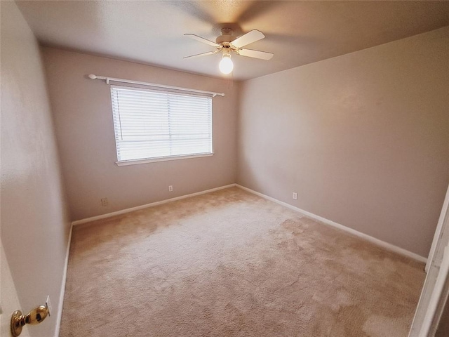 unfurnished room featuring ceiling fan and light carpet