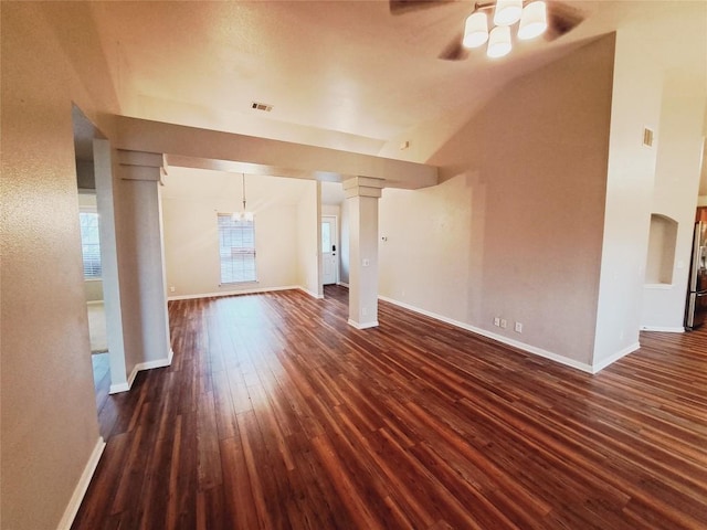 unfurnished living room with dark wood-type flooring, ceiling fan, high vaulted ceiling, and decorative columns