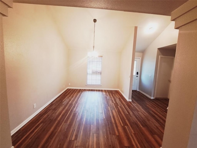 interior space with dark hardwood / wood-style flooring and vaulted ceiling