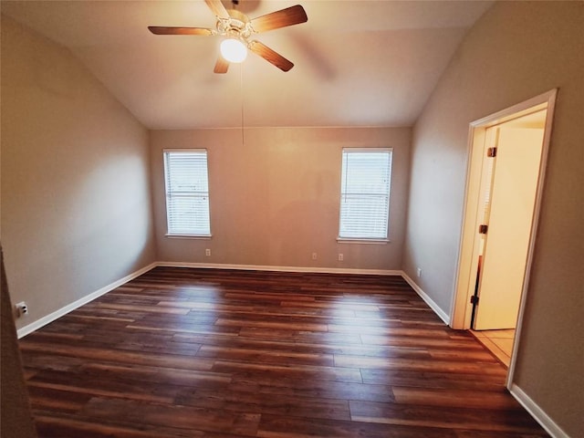 empty room featuring ceiling fan, lofted ceiling, and dark hardwood / wood-style floors