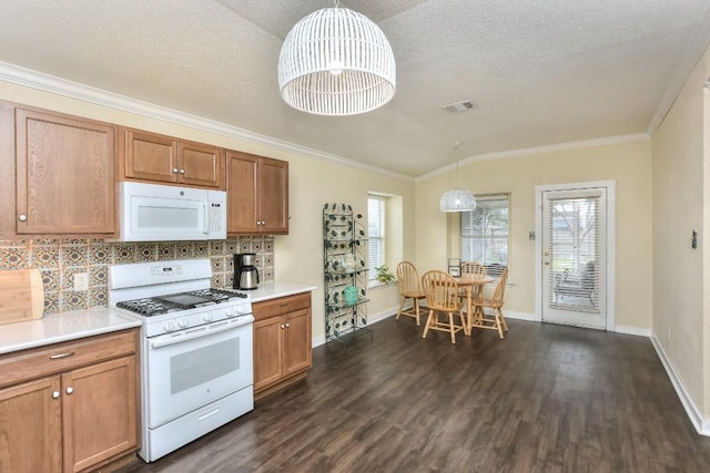 kitchen with pendant lighting, white appliances, backsplash, dark hardwood / wood-style floors, and ornamental molding