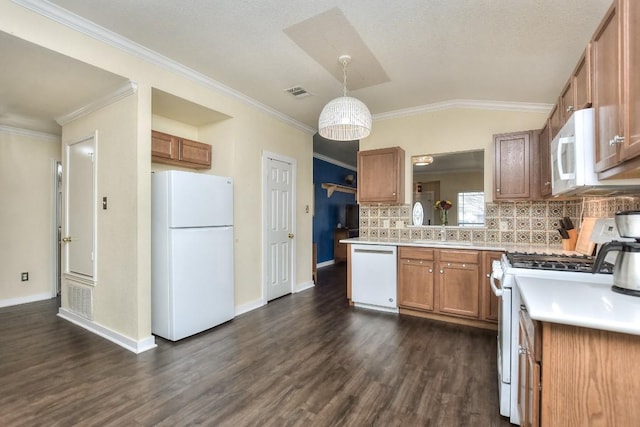 kitchen featuring pendant lighting, lofted ceiling, white appliances, backsplash, and dark hardwood / wood-style flooring