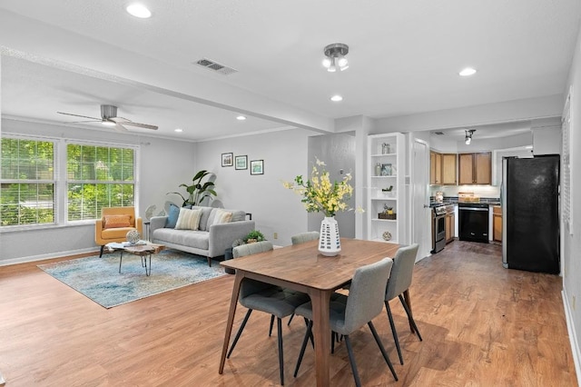 dining space with ceiling fan and light hardwood / wood-style flooring