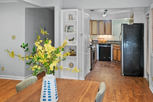 kitchen with stainless steel appliances and dark hardwood / wood-style flooring