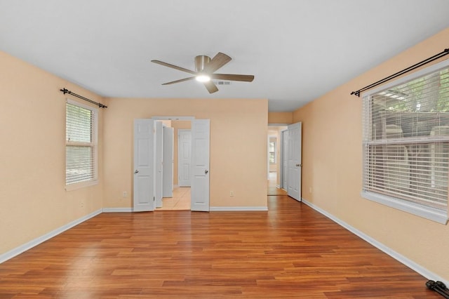 unfurnished bedroom with ceiling fan and light hardwood / wood-style floors