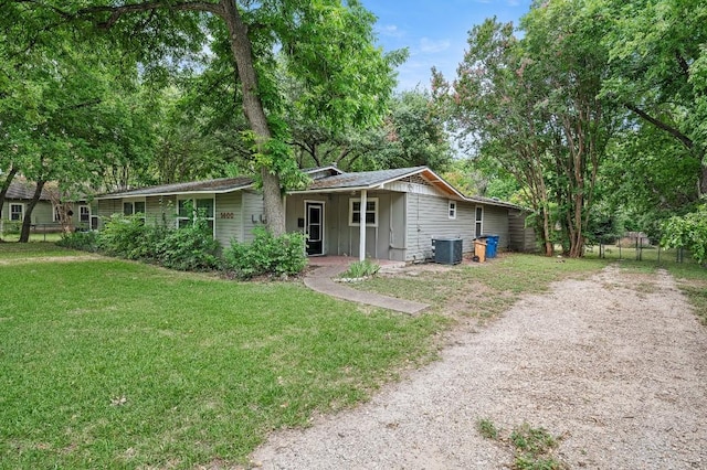 view of front of house featuring central AC unit and a front lawn