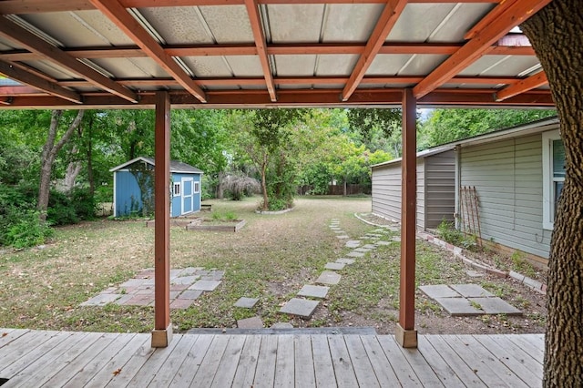 view of yard featuring a storage shed and a deck