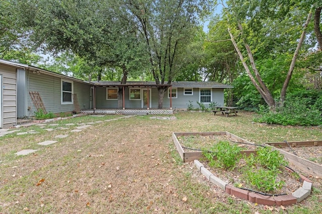 rear view of house featuring a lawn