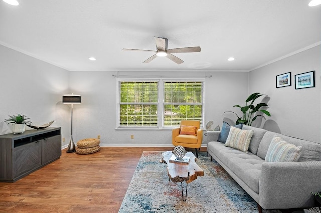 living room featuring ornamental molding, ceiling fan, and light hardwood / wood-style floors