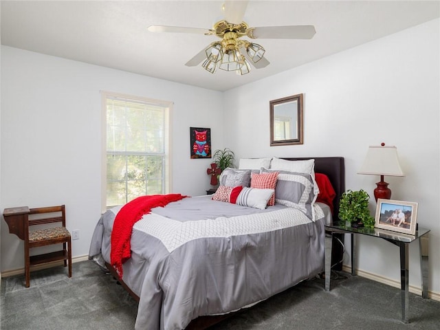 bedroom with ceiling fan and dark colored carpet