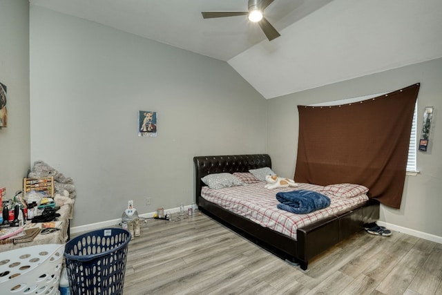 bedroom with light wood-type flooring, lofted ceiling, and ceiling fan