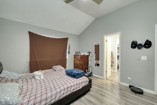 bedroom with light hardwood / wood-style flooring and lofted ceiling