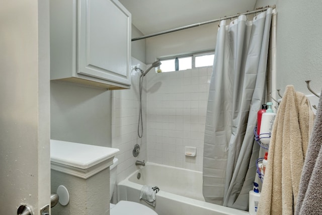 bathroom with shower / bath combination with curtain and toilet