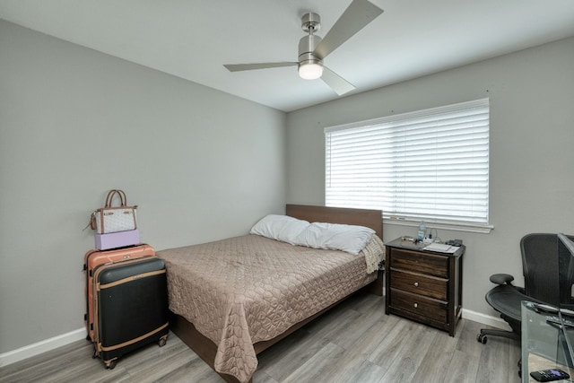 bedroom with ceiling fan and light hardwood / wood-style floors