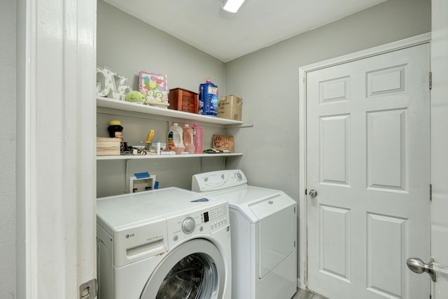 clothes washing area with washing machine and clothes dryer